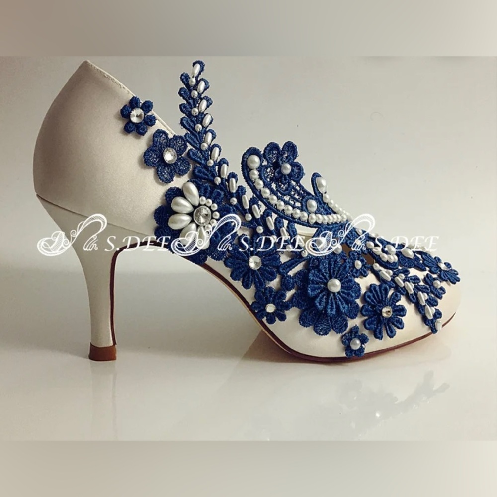 Brand new, never worn. size 7,  3 inch ivory peep toe with electric blue flowers